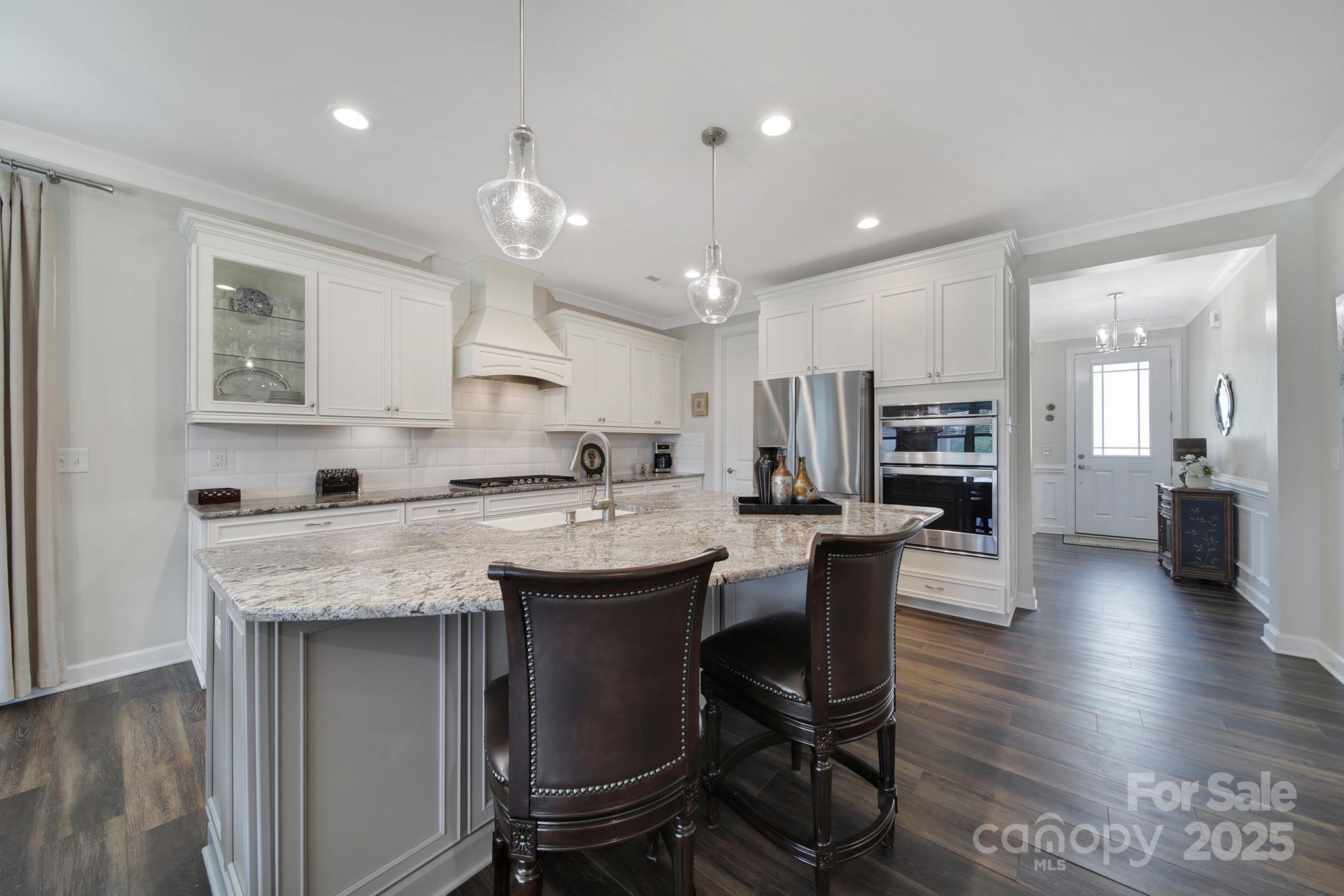 537 Lincoln Quarters Lane Fort Mill, SC 29708 - Photo 6 of 42 a kitchen with stainless steel appliances granite countertop a table chairs sink refrigerator and cabinets