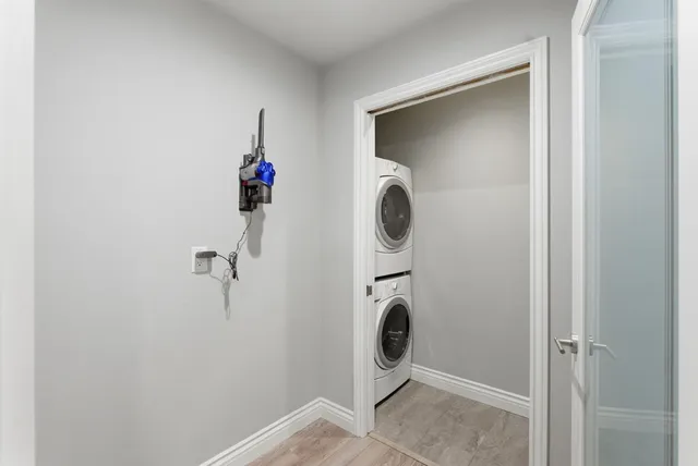 a room with a walk in closet and wooden floor