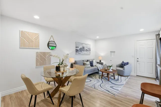 a view of a dining room with furniture and wooden floor