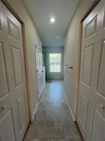 a spacious bathroom with a granite countertop sink a toilet and a mirror