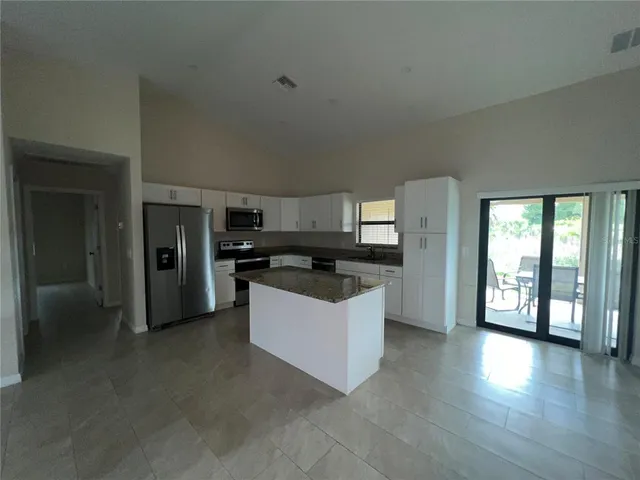 a kitchen with a refrigerator and a sink