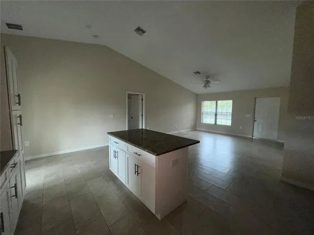 an empty room with fireplace and wooden floor