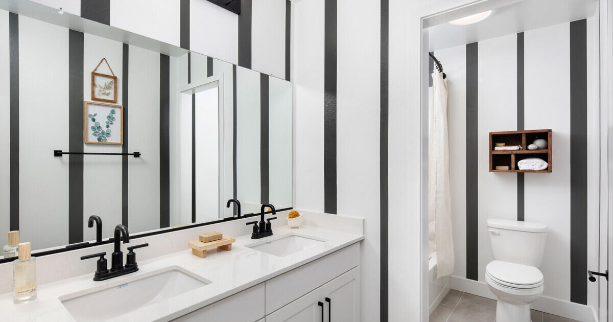 42401 Lamporo Way Indio, CA 92203 - Photo 14 of 15 a bathroom with a double vanity sink toilet and shower