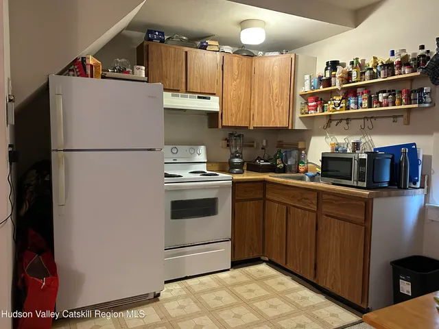 a kitchen with cabinets and white appliances