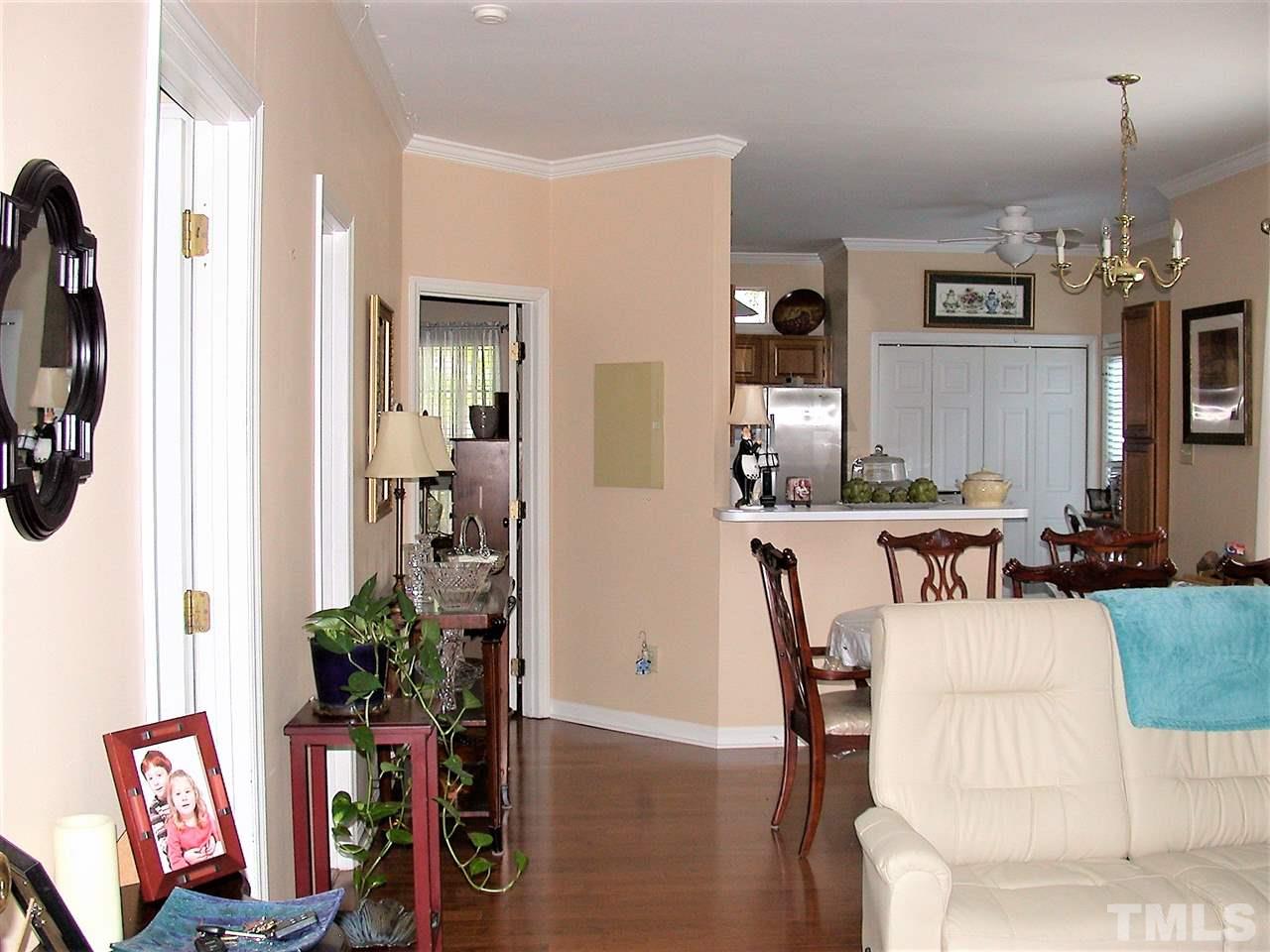 4466 Still Pines Drive Raleigh, NC 27613 - Photo 3 of 13 a view of a dining room with furniture and a flat screen tv