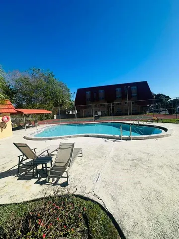 a view of a swimming pool with a lounge chair