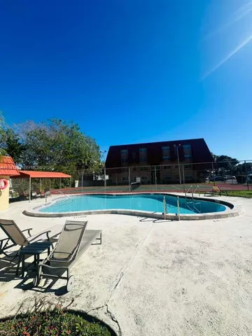 a view of a road with wooden fence
