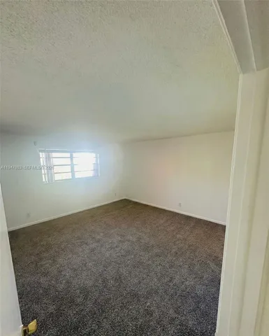 an empty room with a empty space and a window