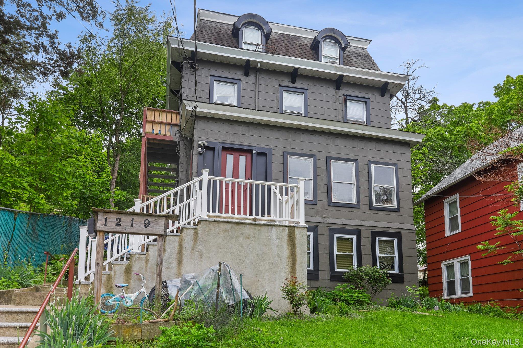 a front view of a house with garden