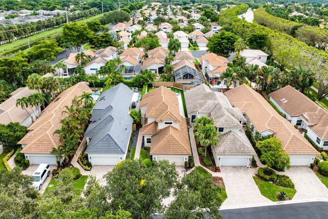 an aerial view of a house with a yard and a fountain