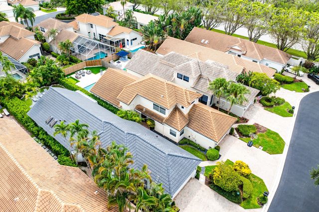 an aerial view of a house with swimming pool and outdoor seating
