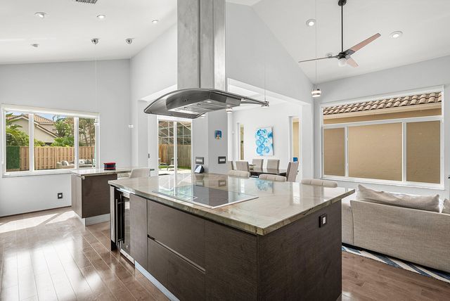 a kitchen with stainless steel appliances granite countertop a sink a stove and a refrigerator