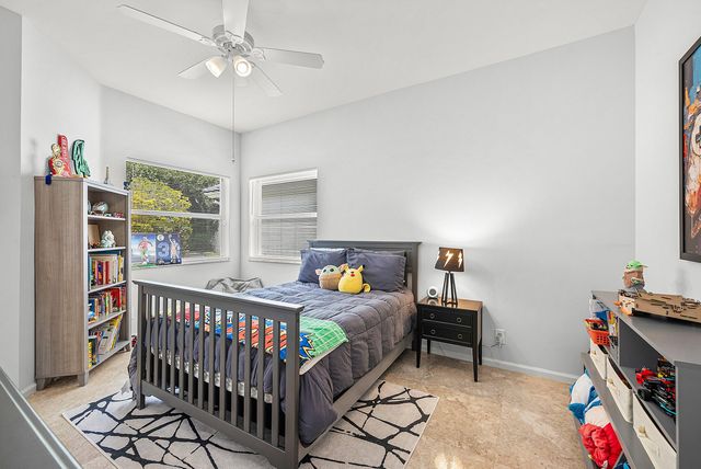 a bedroom with furniture a rug and a window