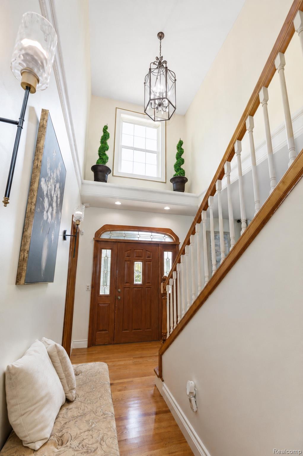 21280 Merriman Road New Boston, MI 48164 - Photo 6 of 65 Hardwood flooring, wood entry door with glass panels, recessed lighting, chandelier, and a wood staircase with white balusters