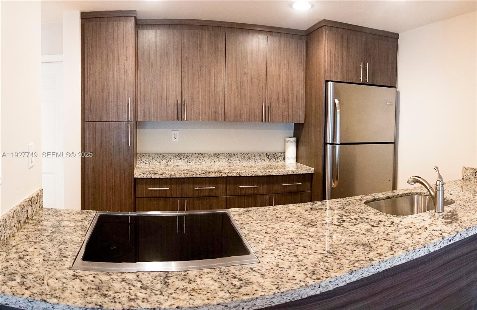 9651 Southwest 77th Avenue, Unit 304E Miami, FL 33156 - Photo 12 of 19 a kitchen with a refrigerator and a sink