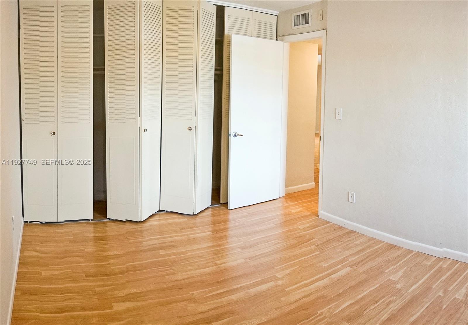 9651 Southwest 77th Avenue, Unit 304E Miami, FL 33156 - Photo 14 of 19 a view of an empty room with wooden floor
