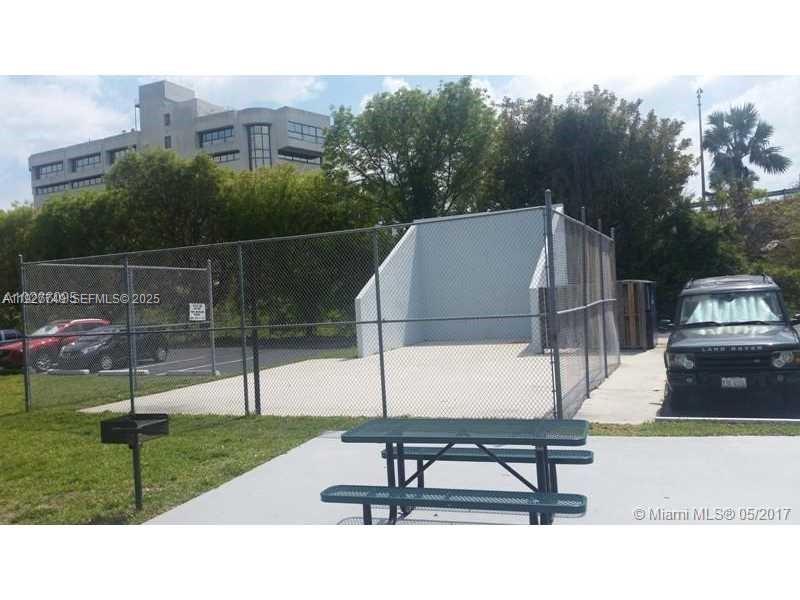 9651 Southwest 77th Avenue, Unit 304E Miami, FL 33156 - Photo 5 of 19 a park view with a bench in the background