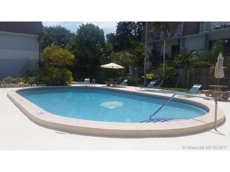 9651 Southwest 77th Avenue, Unit 304E Miami, FL 33156 - Photo 7 of 19 a view of outdoor space yard swimming pool and patio