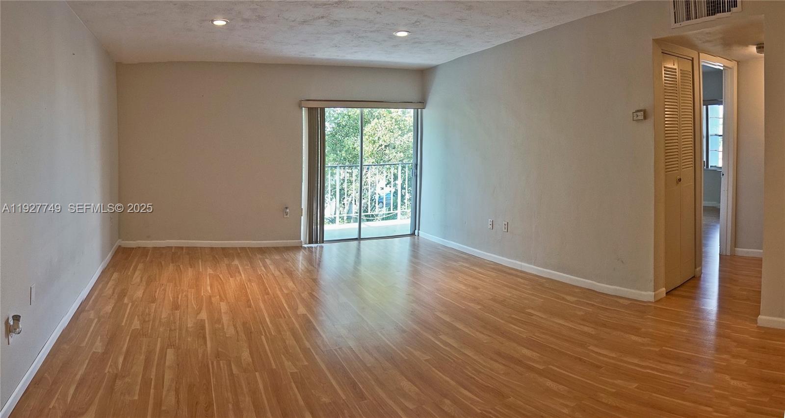 9651 Southwest 77th Avenue, Unit 304E Miami, FL 33156 - Photo 8 of 19 wooden floor in an empty room with a window