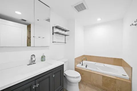a bathroom with a sink a toilet and a bathtub