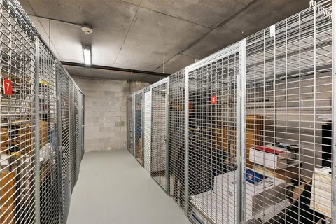 a kitchen with stainless steel appliances granite countertop a refrigerator and a view of living room