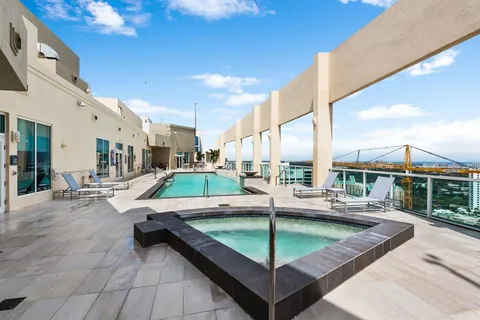 a view of a balcony with two chairs and a potted plant