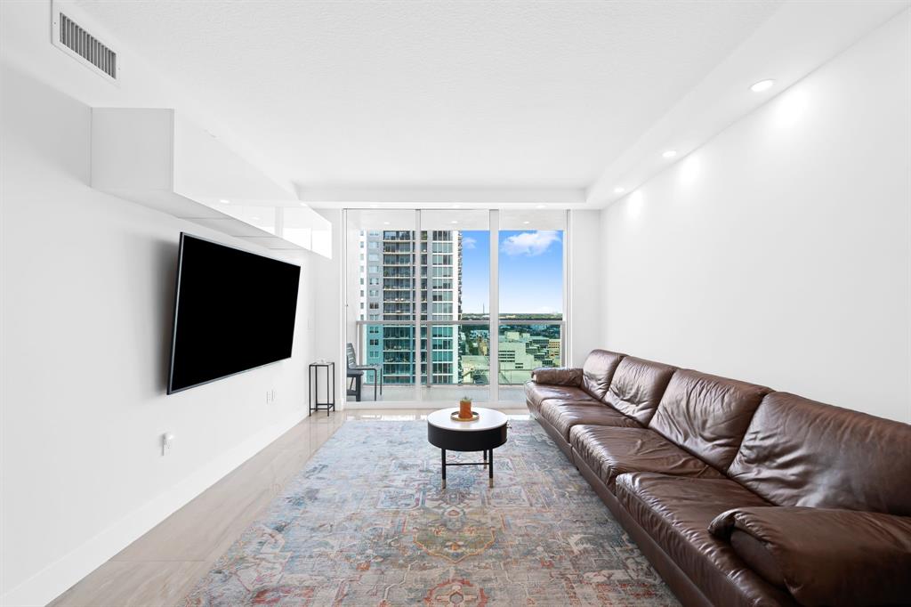 350 Southeast 2nd Street, Unit 2280 Fort Lauderdale, FL 33301 - Photo 4 of 25 a living room with furniture and a flat screen tv