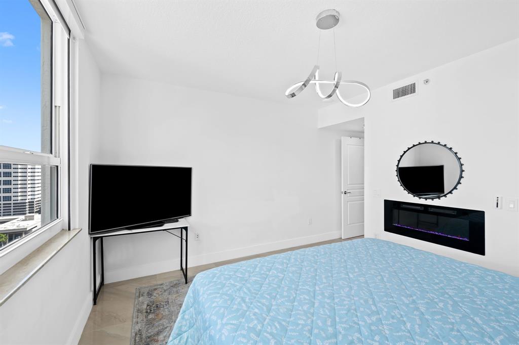 350 Southeast 2nd Street, Unit 2280 Fort Lauderdale, FL 33301 - Photo 6 of 25 a living room with furniture and a flat screen tv