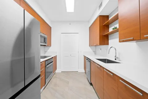 a kitchen with stainless steel appliances granite countertop a sink and a stove