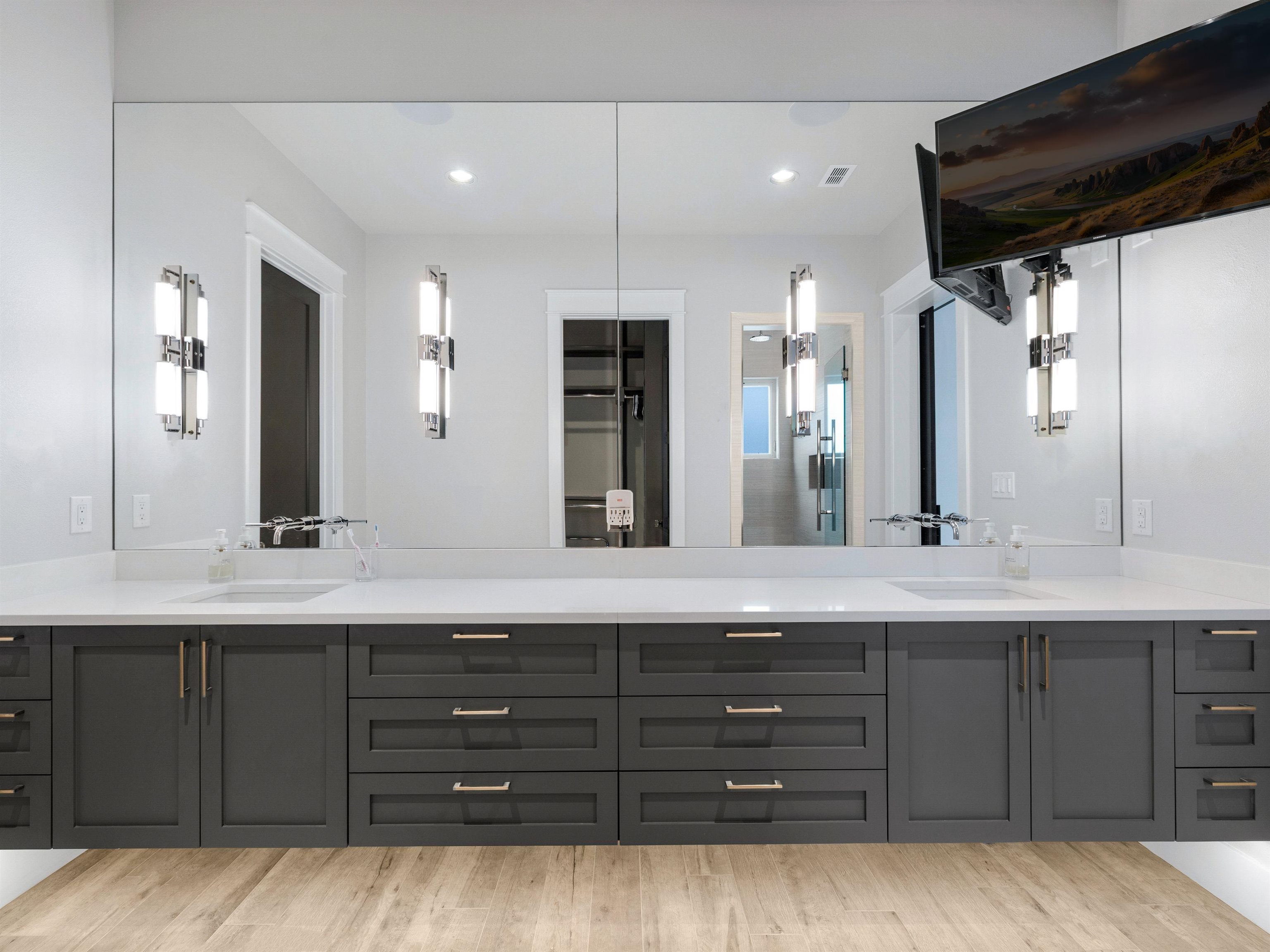 107 Paradise Point Kingsland, TX 78639 - Photo 23 of 40 a bathroom with a double vanity sink and a large mirror