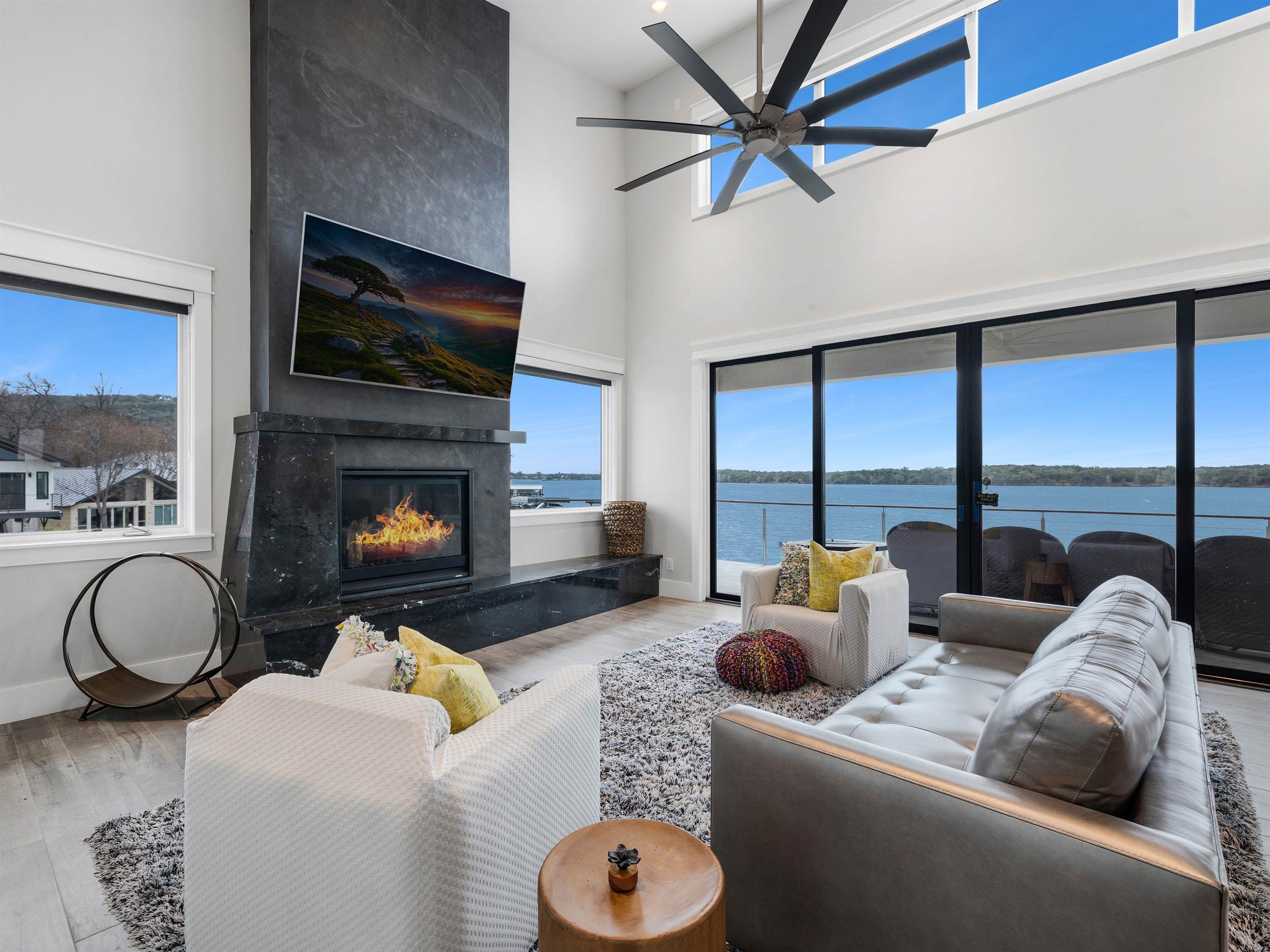 107 Paradise Point Kingsland, TX 78639 - Photo 4 of 40 a living room with furniture a large window and a fireplace