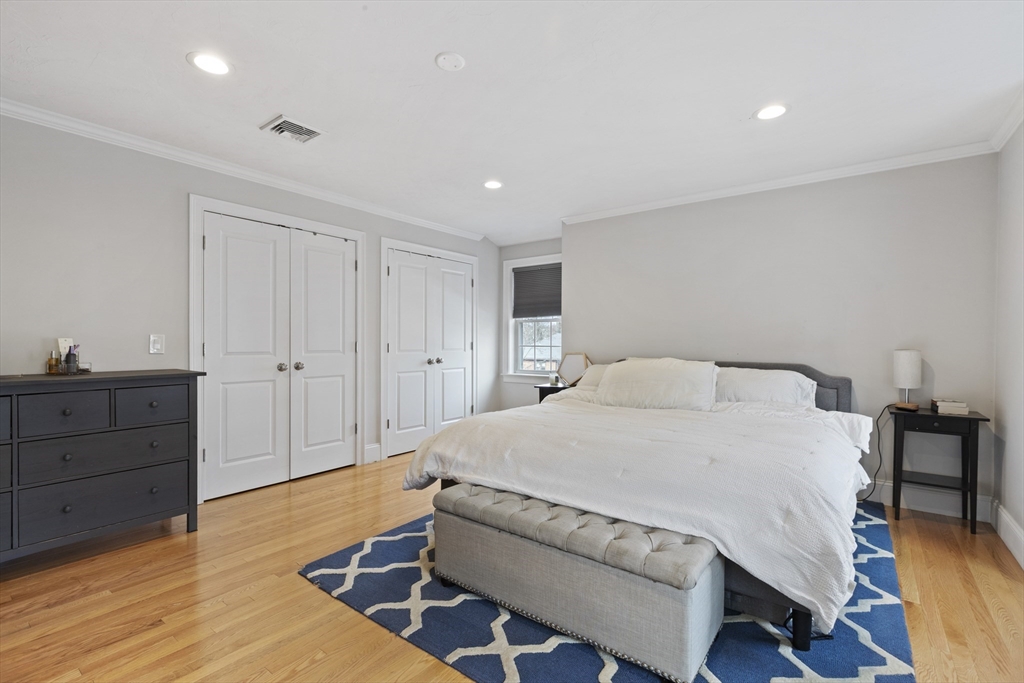 113 Elm Street, Unit D Quincy, MA 02169 - Photo 16 of 39 a spacious bedroom with a bed and a dresser