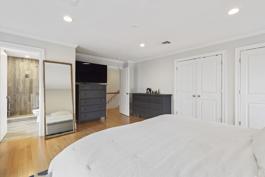 113 Elm Street, Unit D Quincy, MA 02169 - Photo 17 of 39 a large bedroom with a bed and a television