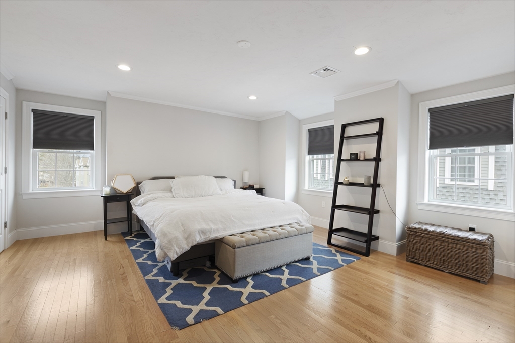 113 Elm Street, Unit D Quincy, MA 02169 - Photo 18 of 39 a spacious bedroom with a bed and a window