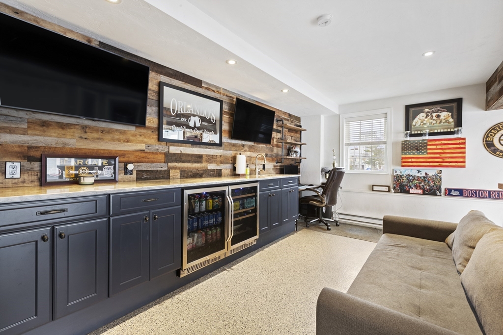 113 Elm Street, Unit D Quincy, MA 02169 - Photo 24 of 39 a living room with stainless steel appliances kitchen island granite countertop furniture and a flat screen tv