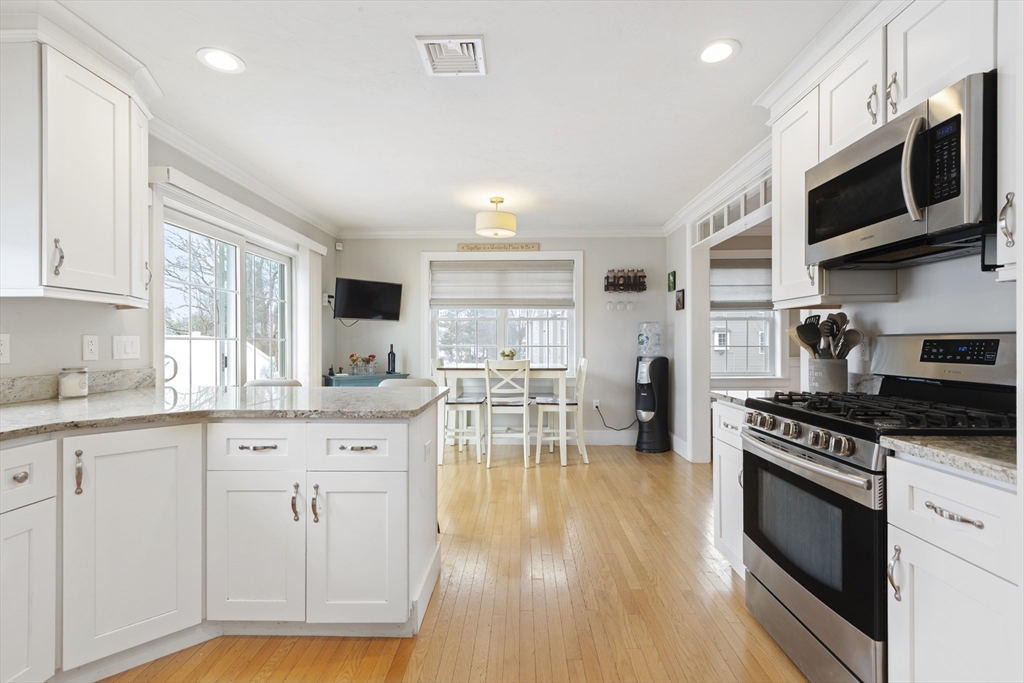 113 Elm Street, Unit D Quincy, MA 02169 - Photo 5 of 39 a kitchen with stainless steel appliances granite countertop a stove and cabinets