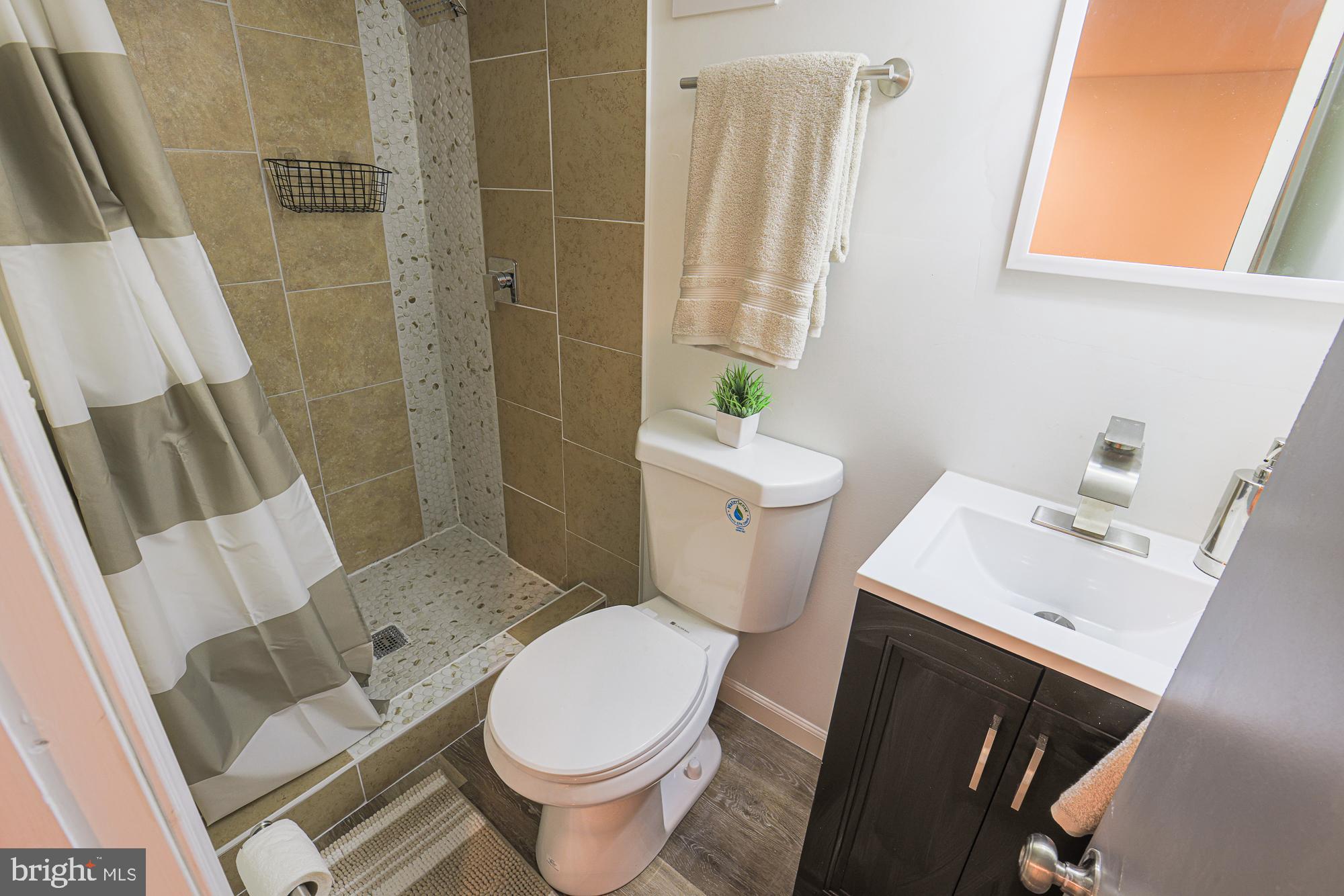 1909 Mosher Street Baltimore, MD 21217 - Photo 24 of 40 a bathroom with a sink toilet and shower