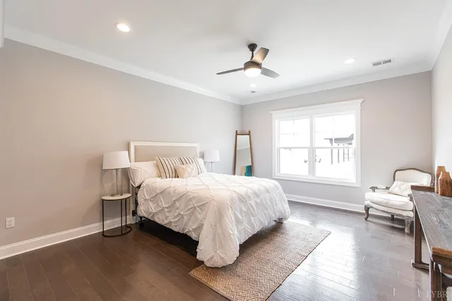 an empty room with windows and ceiling fan