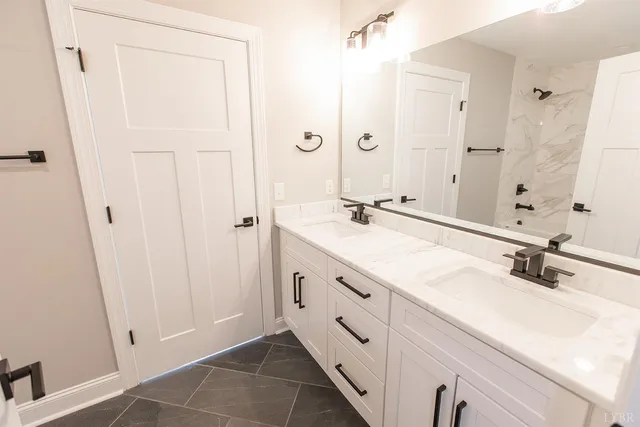 a bathroom with a shower sink and mirror