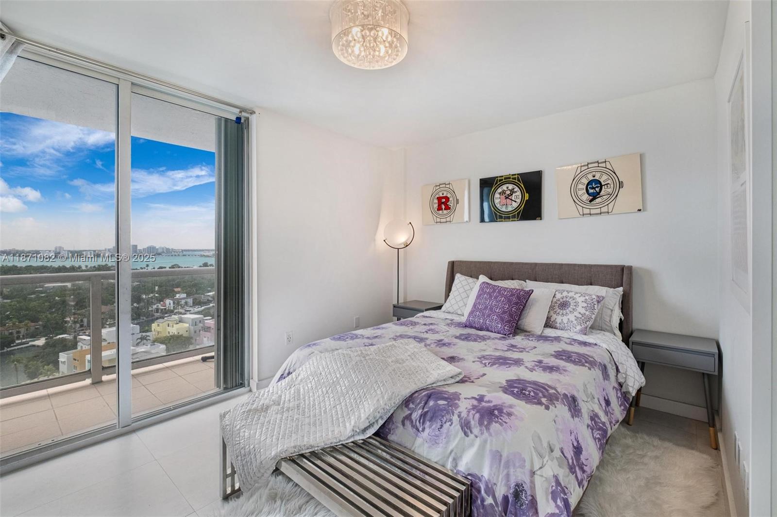5900 Collins Avenue, Unit 1905 Miami Beach, FL 33140 - Photo 16 of 22 a bedroom with a large bed and a large window