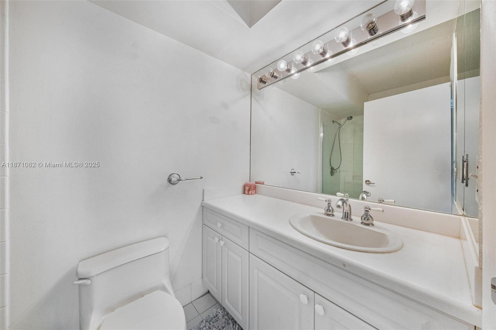 5900 Collins Avenue, Unit 1905 Miami Beach, FL 33140 - Photo 17 of 22 a bathroom with a sink toilet and shower