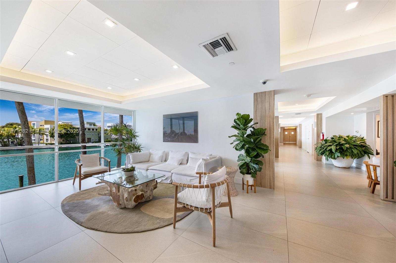 5900 Collins Avenue, Unit 1905 Miami Beach, FL 33140 - Photo 18 of 22 a living room with furniture potted plant and kitchen view