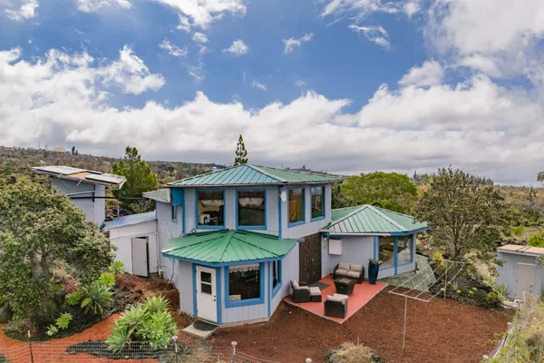 a view of a patio with a table and chairs under an umbrella