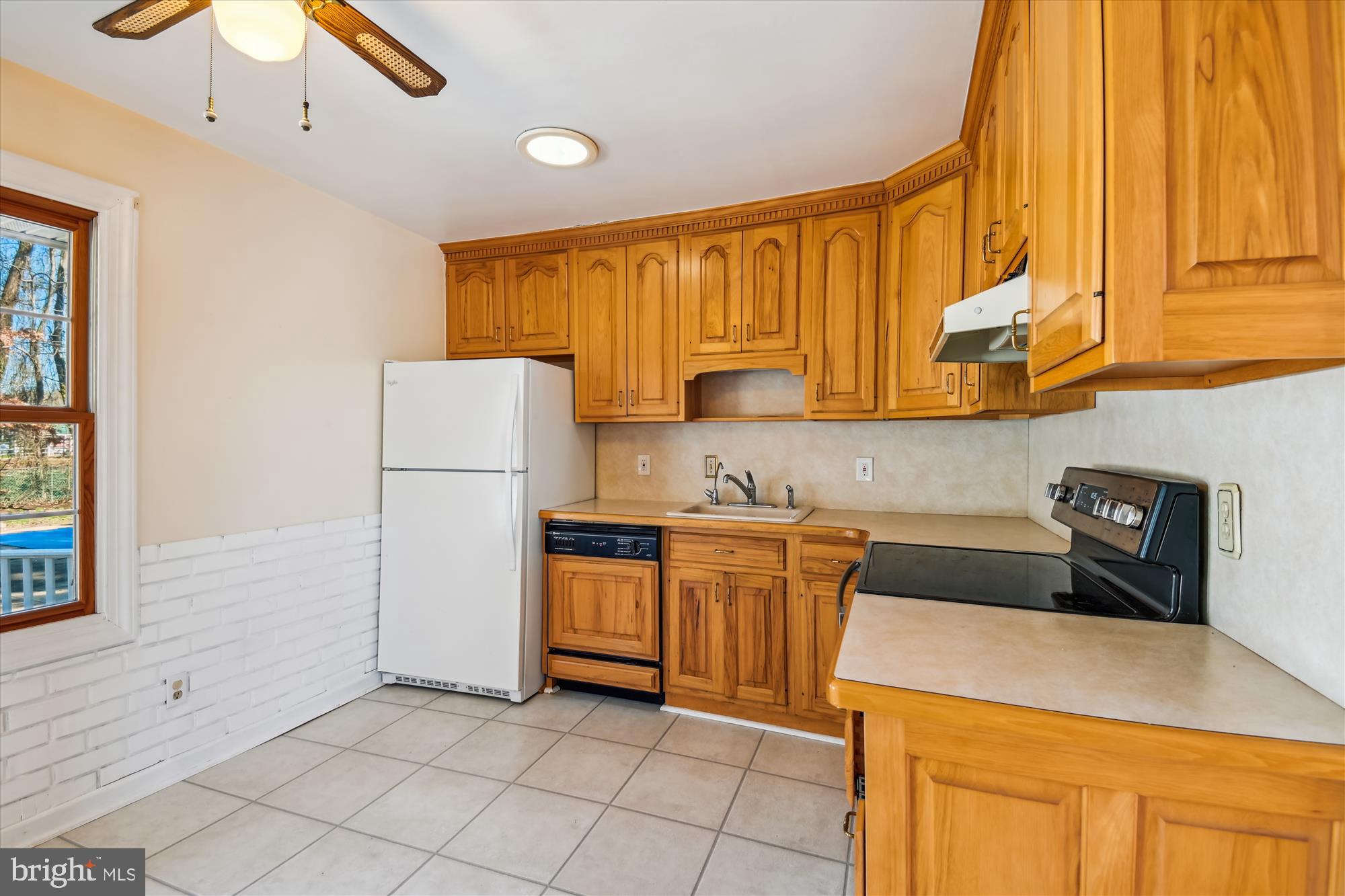 1574 Melanie Road Pasadena, MD 21122 - Photo 12 of 41 a kitchen with stainless steel appliances granite countertop a refrigerator a stove a sink dishwasher and wooden cabinets