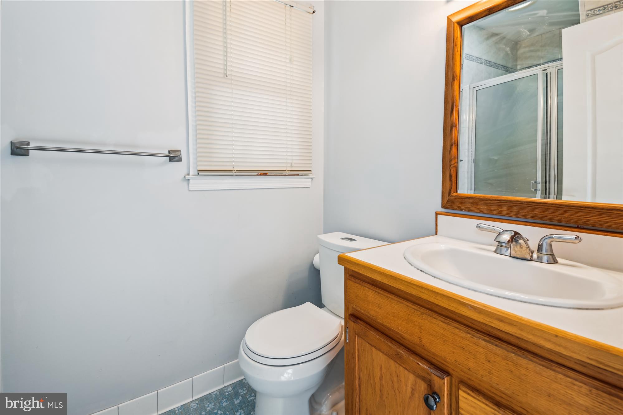 1574 Melanie Road Pasadena, MD 21122 - Photo 18 of 41 a bathroom with a sink toilet and mirror