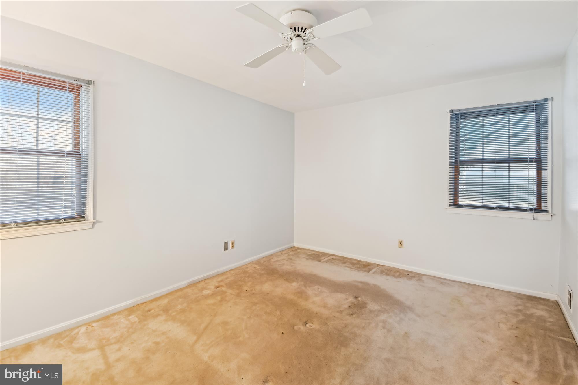 1574 Melanie Road Pasadena, MD 21122 - Photo 19 of 41 an empty room with windows and ceiling fan