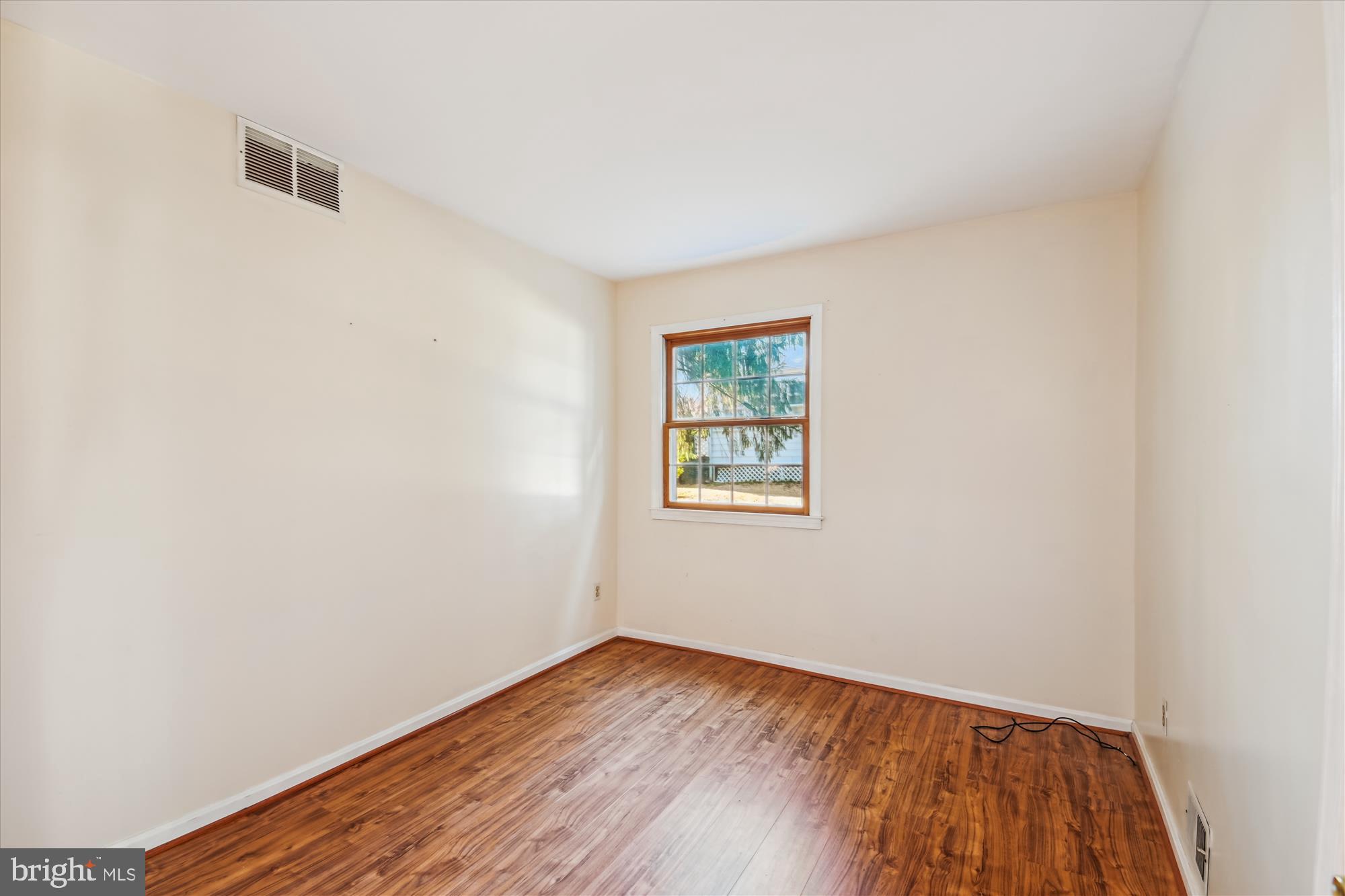 1574 Melanie Road Pasadena, MD 21122 - Photo 21 of 41 an empty room with wooden floor and windows