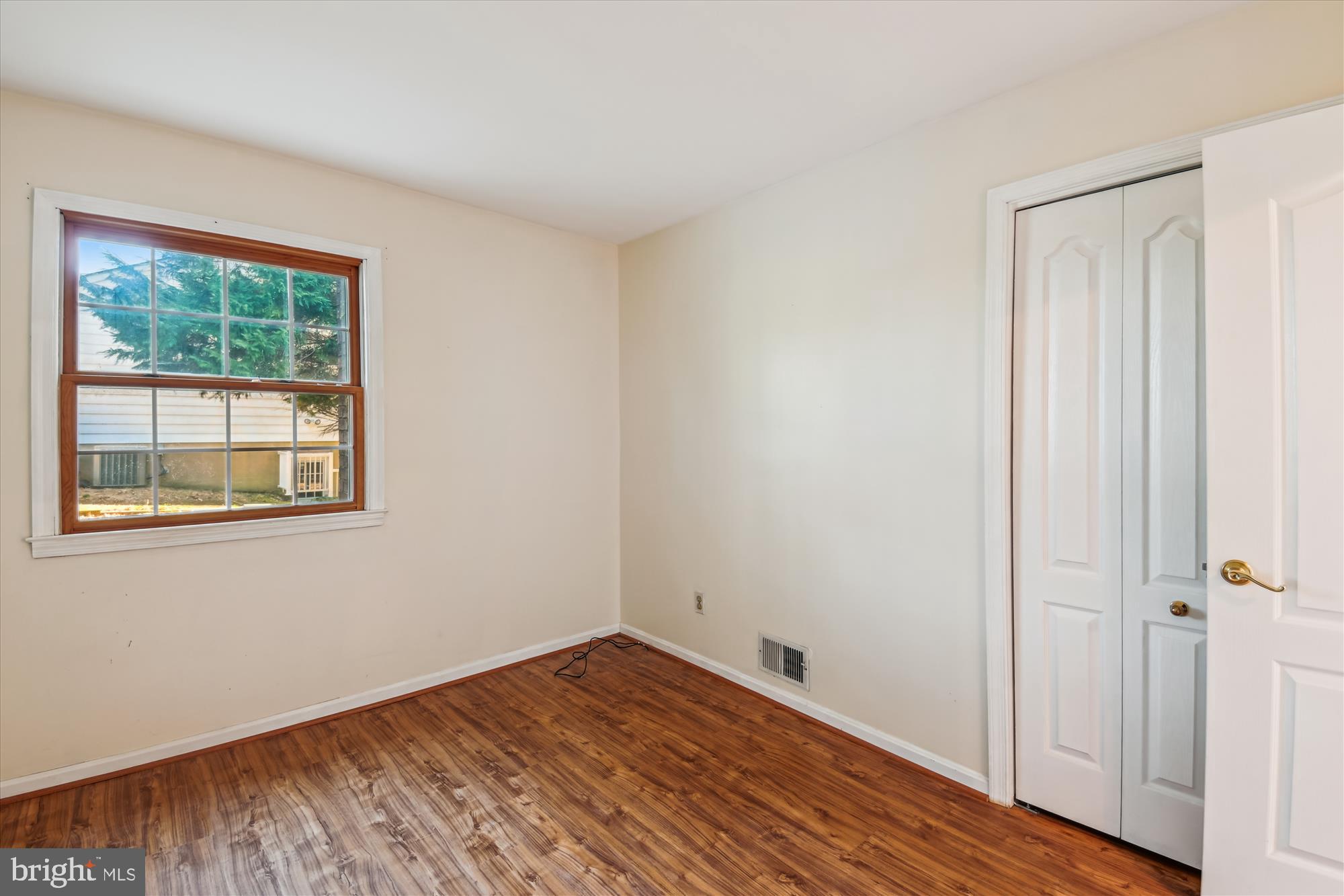 1574 Melanie Road Pasadena, MD 21122 - Photo 22 of 41 an empty room with wooden floor and windows