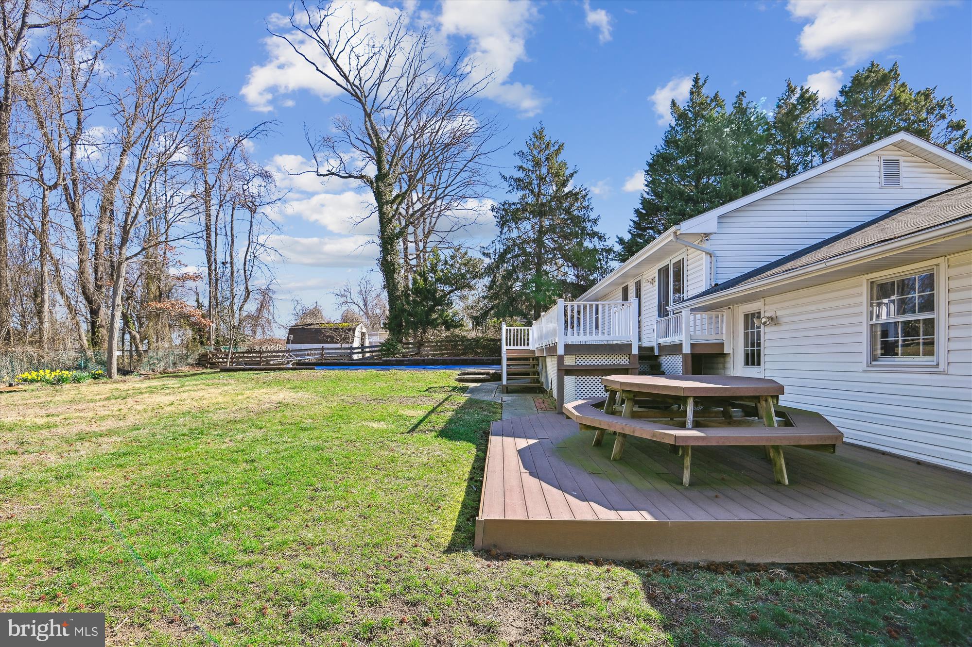 1574 Melanie Road Pasadena, MD 21122 - Photo 33 of 41 a small white house with a white roof and a yard