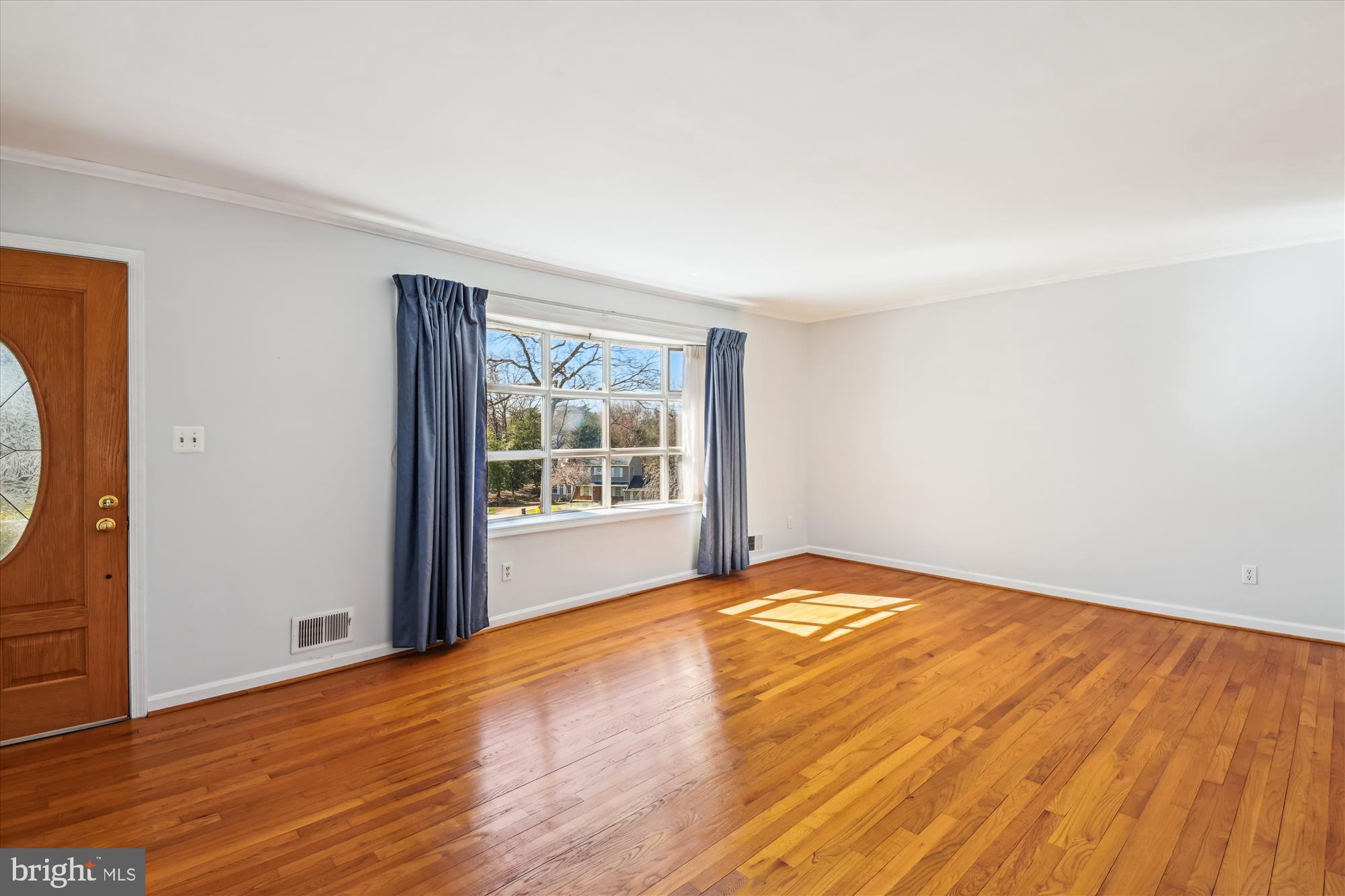 1574 Melanie Road Pasadena, MD 21122 - Photo 6 of 41 a view of an empty room with wooden floor and a window
